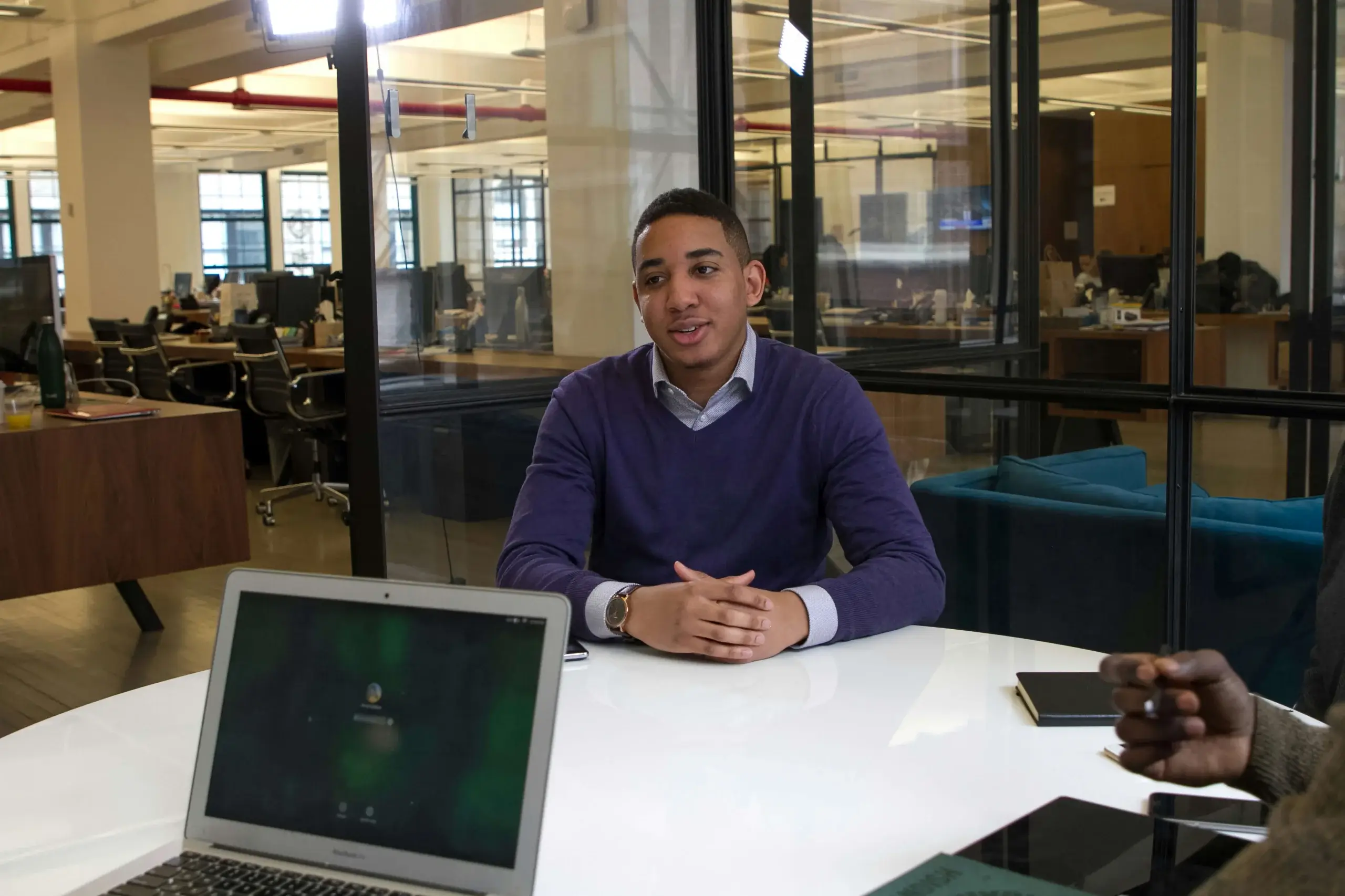 a man is being interviewed for a job in the office