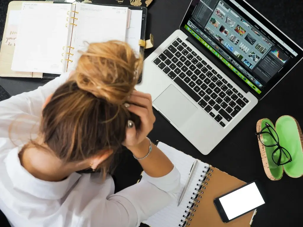 a woman holding her head has got a job rejection