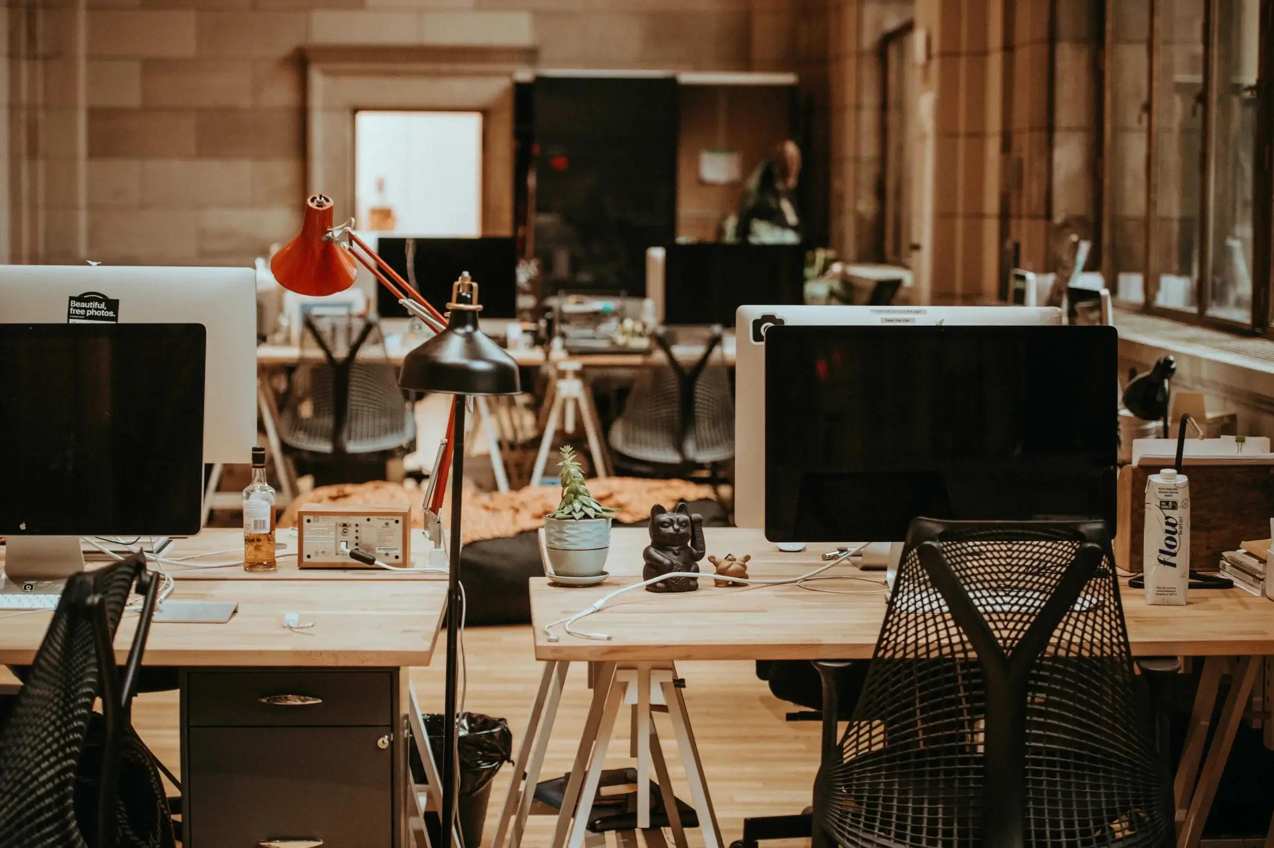 warm and cozy office workplace with computers and desks
