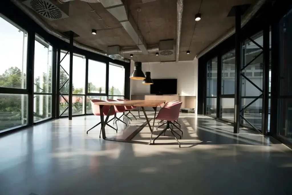 modern workplace with a huge conference room with multiple chairs and a big desk
