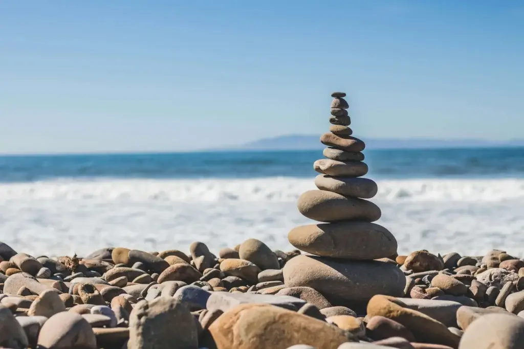 stones stacked on top of each other on the beach, demonstrating balance