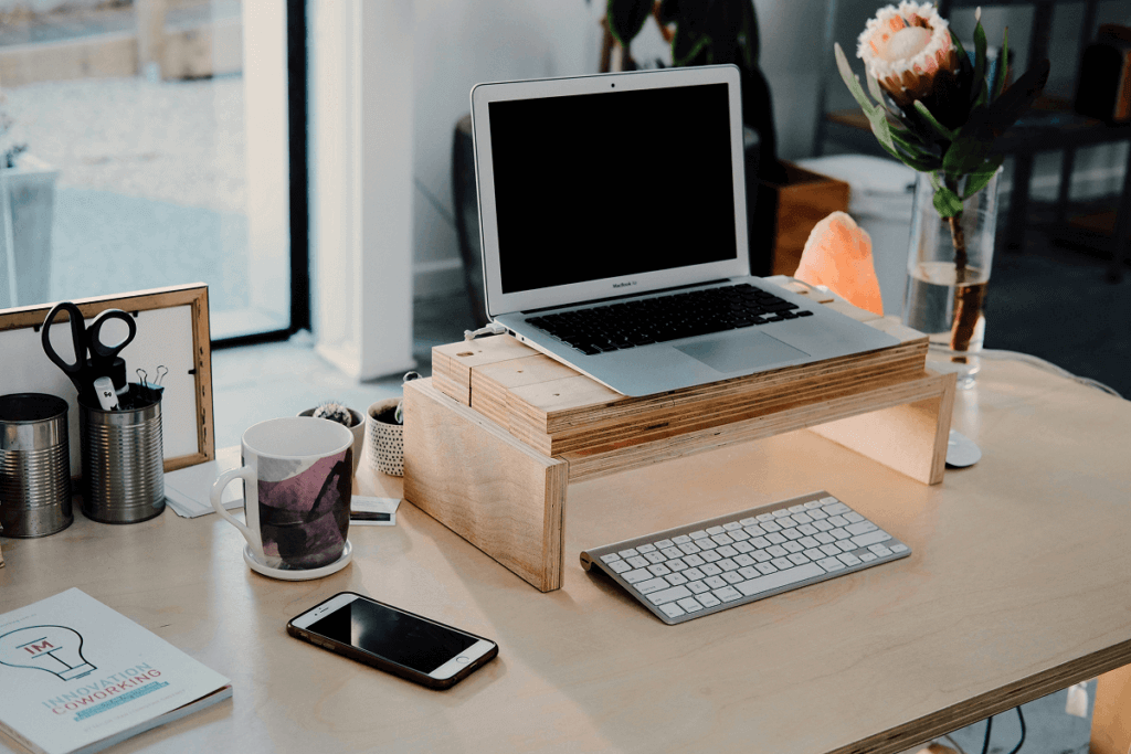 Ergonomic home workspace with a laptop stand and aesthetic decor.