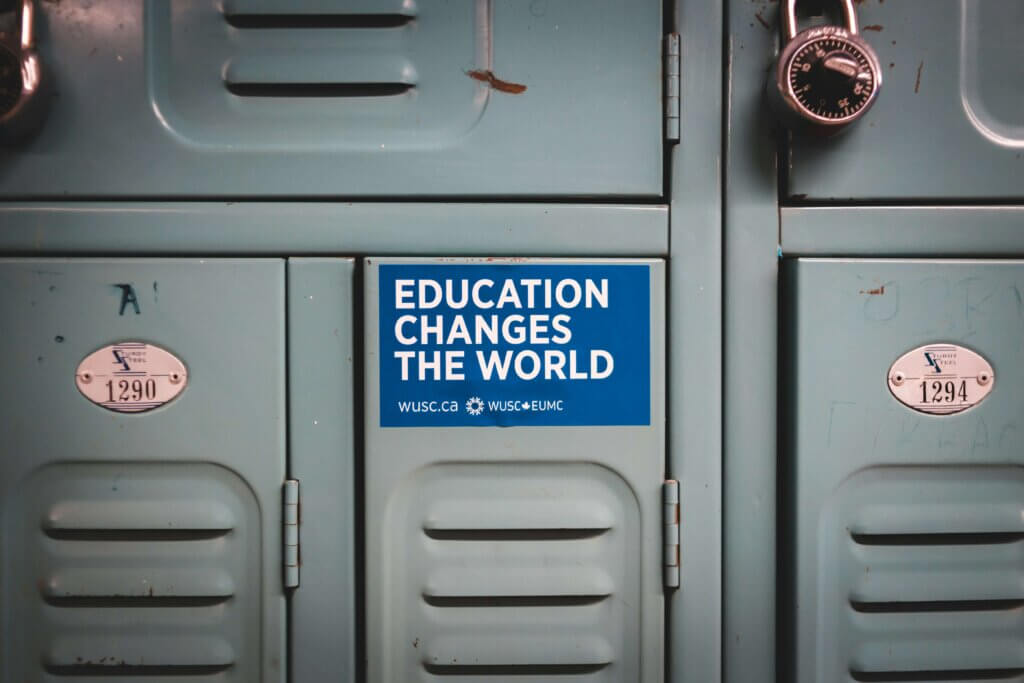 a sticker attached to a locker with a caption Education Changes the World