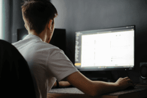 Man working from a desktop in a home office, illustrating a focused approach to how to find remote work.